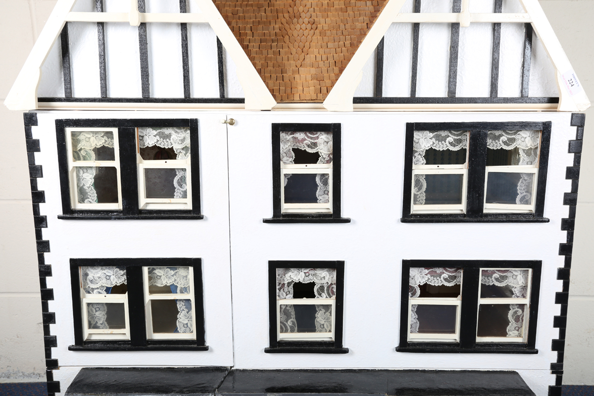 A 20th century Tudor style doll's house, the double-gabled tiled roof above a double opening front - Image 20 of 21