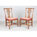 A pair of George III Chippendale period mahogany carved and pierced splat back dining chairs with