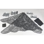 A large collection of black lace items, including Maltese lace borders and a large Chantilly lace
