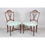 A pair of George III Hepplewhite period mahogany dining chairs with finely carved backs and blue