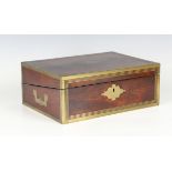 An early 19th century figured mahogany and brass bound writing slope with recessed handles and
