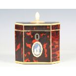 A George III red stained tortoiseshell and ivory mounted canted rectangular tea caddy, the front