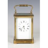 An early 20th century French brass cased carriage timepiece with eight day movement and white enamel