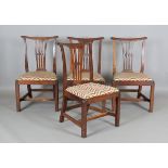 A set of four George III Chippendale period mahogany pierced splat back dining chairs, the drop-in