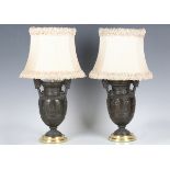 A pair of 20th century brown patinated cast bronze and gilt brass mounted table lamps of classical