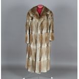 A three-quarter-length lady's fur coat by K. West of London, length 112cm, together with two other
