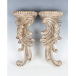 A pair of modern cast composition wall brackets of scroll form, height 30cm, width 14cm. Provenance: