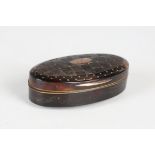 A late George III tortoiseshell oval snuff box, the hinged lid with piqué inlaid gold stars and