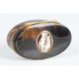 An early 19th century tortoiseshell and gold mounted oval snuff box, the hinged lid inset with an