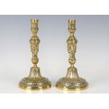 A pair of George III Neoclassical Revival brass candlesticks, the fluted stems cast with swags,