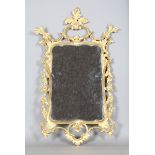 A 20th century George III style carved giltwood and gesso wall mirror, the rococo style frame