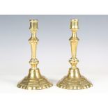A pair of George II brass candlesticks with knop stems and domed octagonal bases, height 23cm.