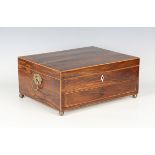 A George III rosewood box with boxwood stringing, the hinged lid above a drawer, raised on brass