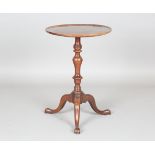 An early George III mahogany circular wine table, the moulded edge top above a turned knop stem