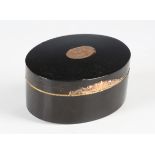 An early 19th century tortoiseshell oval table snuff box, the hinged lid and base with an inlaid