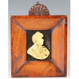 A 19th century gilt metal profile portrait plaque of George IV, mounted within a wide section