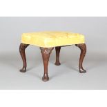 A George II walnut stool, the seat covered in golden yellow damask, raised on carved cabriole legs