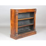 A Regency rosewood open bookcase with a white marble top, the concealed frieze drawer with carved