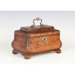 An early George III figured mahogany tea caddy of bombé form, the pagoda moulded lid with a gilt