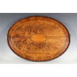 A George III figured mahogany oval tea tray with satinwood oval reserve and tulipwood