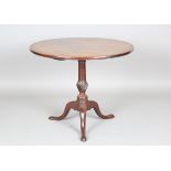 A George III mahogany circular tip-top supper table, the spiral carved stem raised on tripod legs,