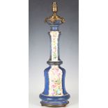 A late 19th century gilt metal mounted porcelain table lamp, painted with bands of roses on a blue