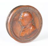 A George III commemorative boxwood circular snuff box, the removable lid decorated in relief with