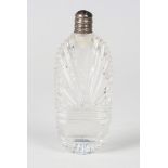 An early 19th century cut clear glass scent bottle of flattened ovoid form, the screw-off silver lid