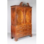 A George III mahogany linen press with tulipwood crossbanding and inlaid fan spandrels, the swan