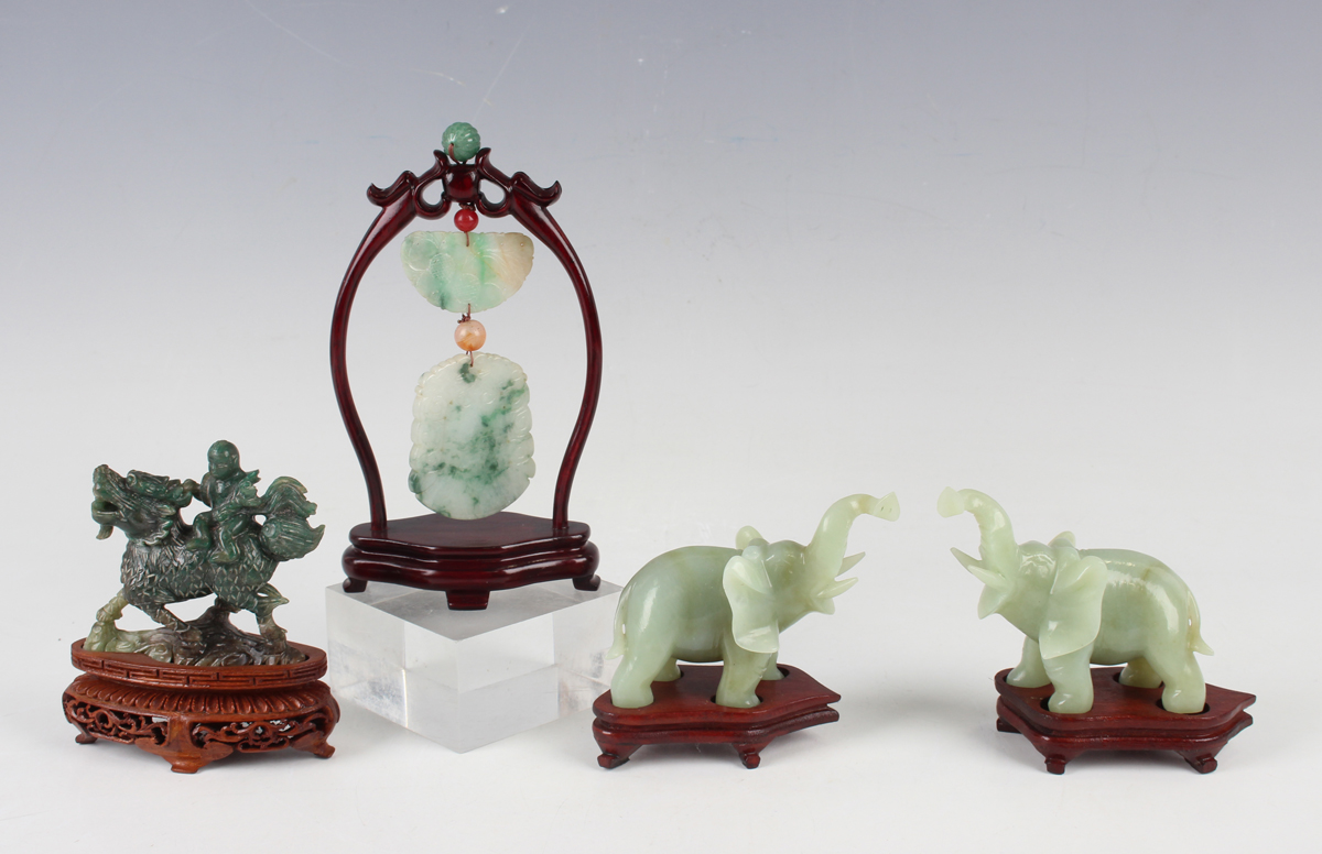 A Chinese jade pendant with wood stand, mid-20th century, the two-piece pendant with carved and