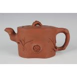 A Chinese Yixing stoneware teapot and cover, late Qing dynasty, of naturalistic branch form,