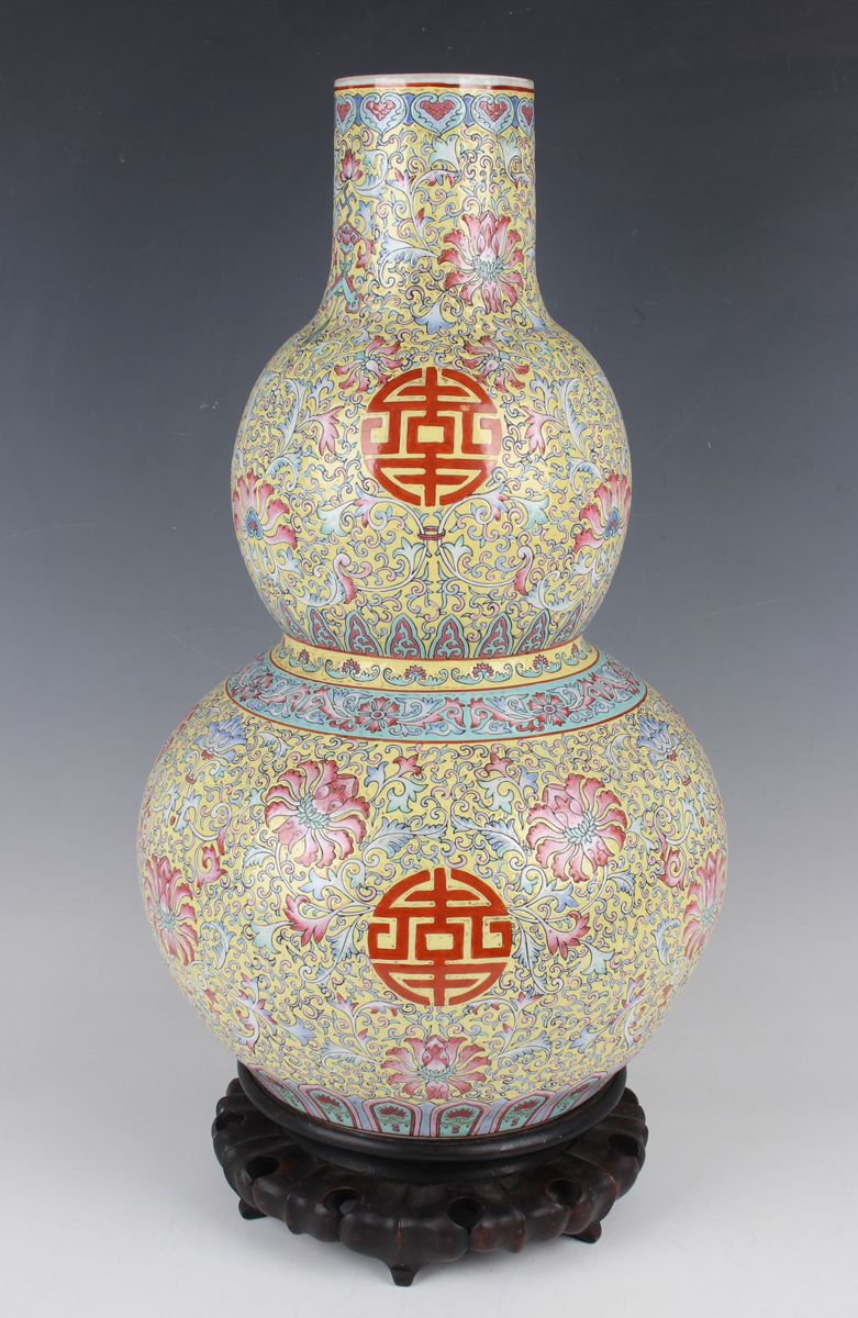 A Chinese famille rose enamelled yellow ground porcelain double gourd shaped vase, mark of