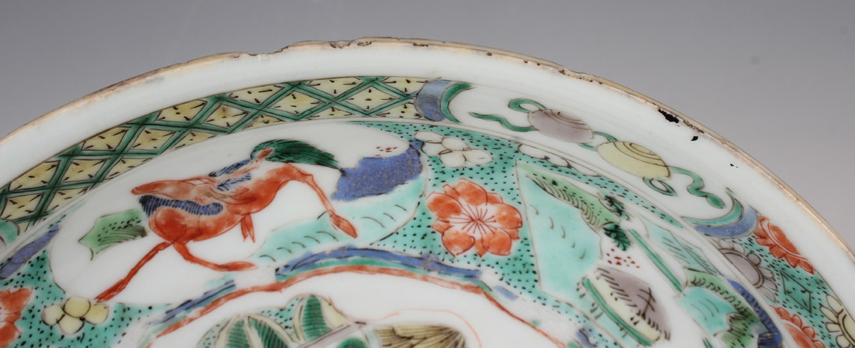 A Chinese famille verte export porcelain saucer dish, Kangxi period, the centre painted with a - Image 3 of 13