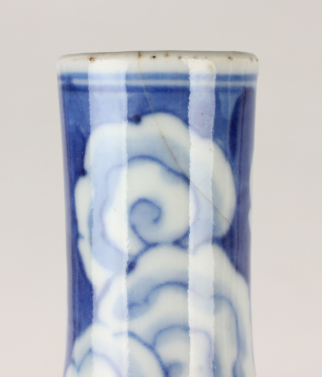 A Chinese blue and white porcelain bottle vase, Qing dynasty, painted with a dragon emerging through - Image 10 of 16