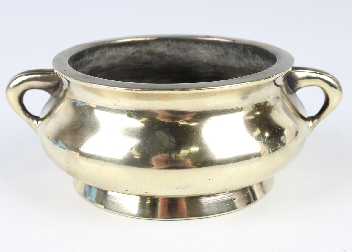 A Chinese polished bronze bombé censer, mark of Xuande but 19th century, the low-bellied circular