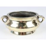 A Chinese polished bronze bombé censer, mark of Xuande but 19th century, the low-bellied circular