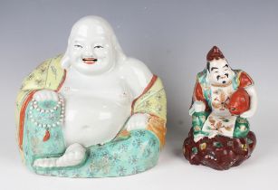 A Chinese porcelain figure of a seated smiling Buddha, early 20th century, modelled wearing an