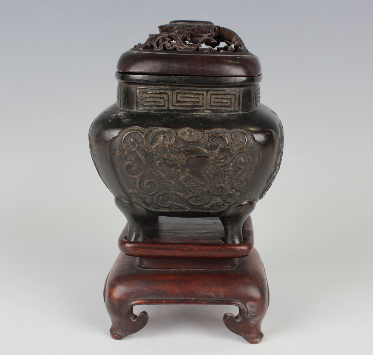 A Chinese brown patinated bronze censer of rounded square form, the body cast with fenghuang panels,