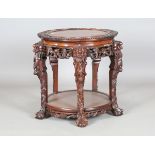 A Chinese hardwood jardinière stand, early 20th century, the lobed circular top with carved border