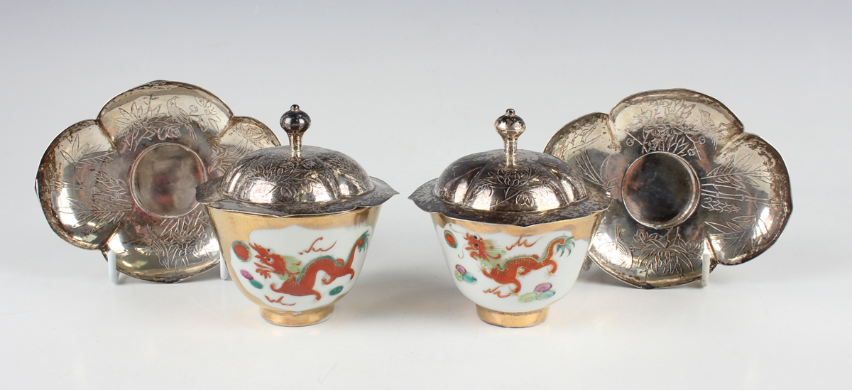 A pair of Chinese porcelain teabowls with silver covers and stands, mid-20th century, each bowl