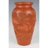 A Japanese red stoneware vase, Meiji period, of shouldered tapering form, modelled in relief with