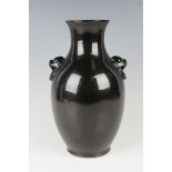 A Chinese black/dark brown glazed porcelain vase, probably 20th century, the ovoid body with moulded