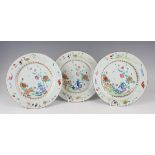 A set of three Chinese famille rose export porcelain plates, Yongzheng period, each painted with a