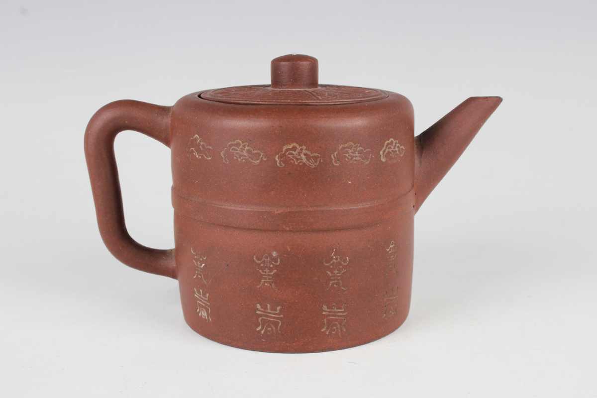 A Chinese Yixing stoneware teapot and cover, late Qing dynasty, the cylindrical body impressed