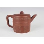 A Chinese Yixing stoneware teapot and cover, late Qing dynasty, the cylindrical body impressed