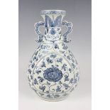 A Chinese Ming-style blue and white porcelain vase, the pear-form body painted with lotus and