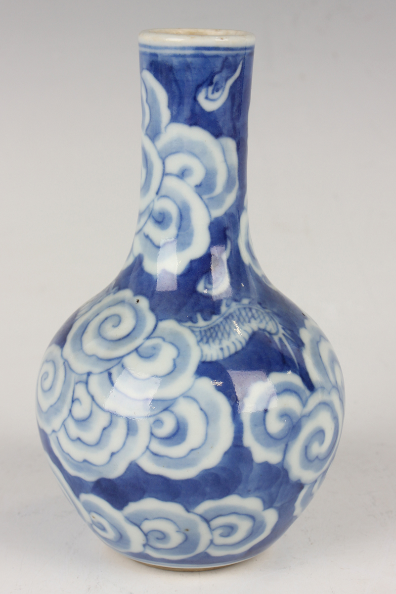 A Chinese blue and white porcelain bottle vase, Qing dynasty, painted with a dragon emerging through - Image 14 of 16