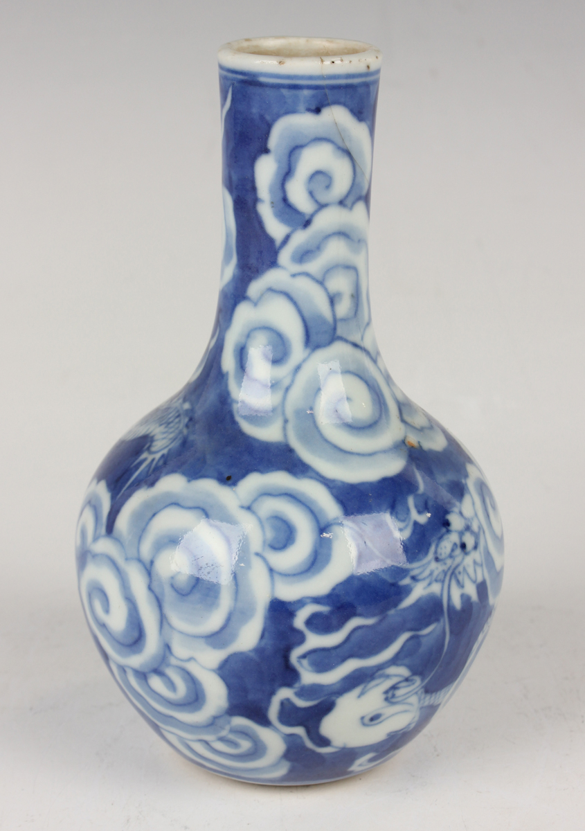 A Chinese blue and white porcelain bottle vase, Qing dynasty, painted with a dragon emerging through - Image 13 of 16