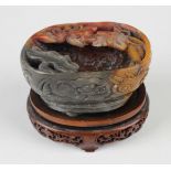 A Chinese soapstone brushwasher, Qing dynasty, of oval form, the top carved and pierced with