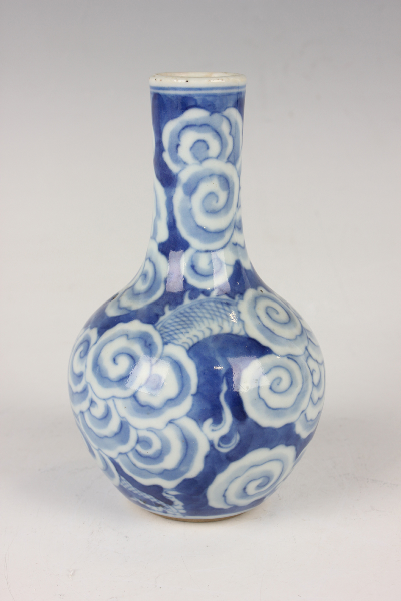 A Chinese blue and white porcelain bottle vase, Qing dynasty, painted with a dragon emerging through - Image 15 of 16